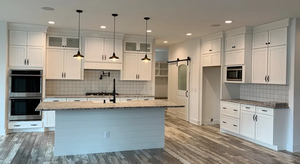 Bright custom kitchen with a large island and pendant lights